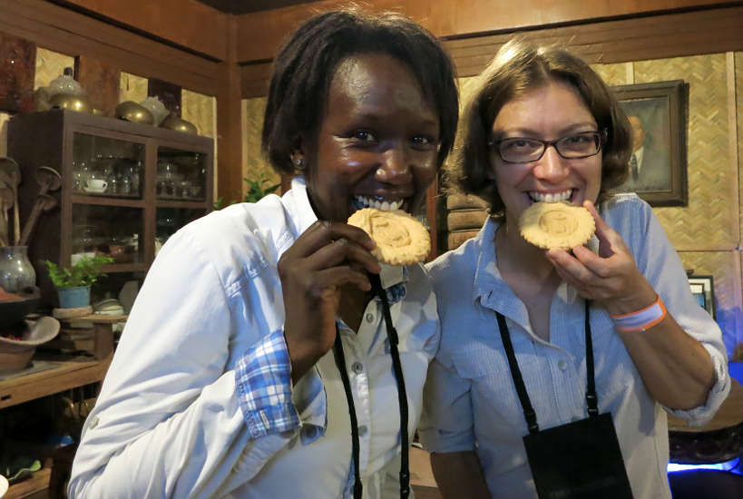 Rosemary and Claire biting into San Nicolas Cookies for Pampanga Cuisine by Authentic Food Quest
