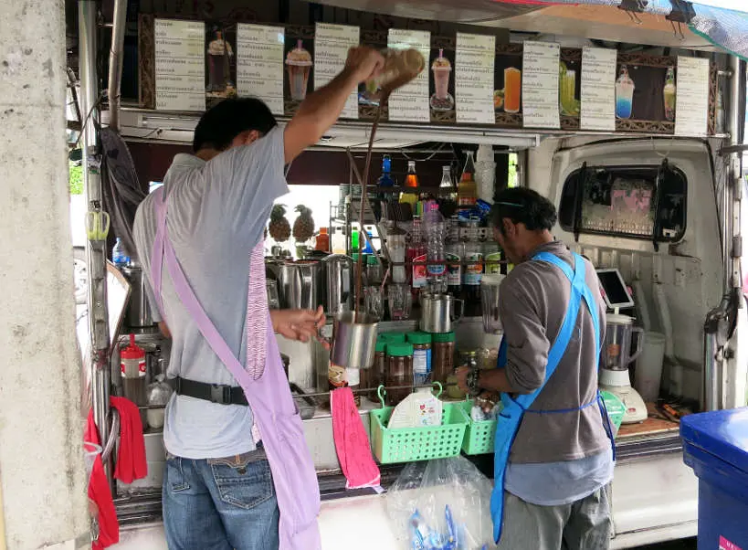 Pouring Thai ice tea Bangkok food tour Authentic Food Quest