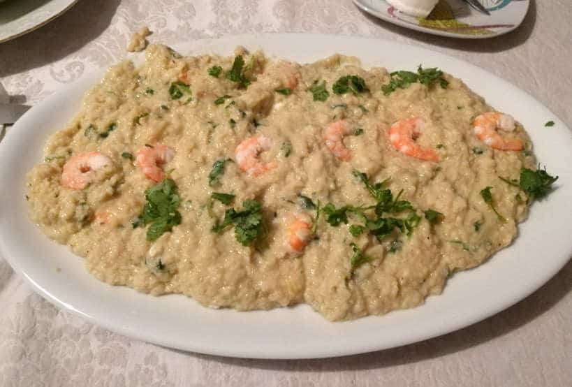 Acorda with Shrimp for Portuguese food and Portuguese Dinner while Eating with Portuguese family by Authentic Food Quest. This acorda was made in a Cooking class in Lisbon with Cristina
