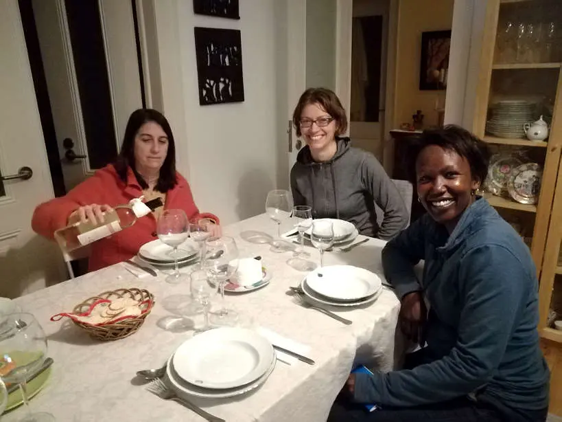 Cristina Claire and Rosemary at Dinning Table for Portuguese food for Portuguese Dinner and Eating with a Portuguese family by Authentic Food Quest