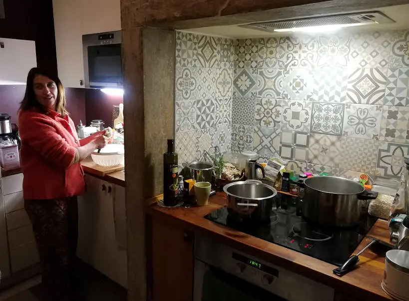 Cristina in her kitchen for Portuguese food and Portuguese Dinner while Eating with Portuguese family by Authentic Food Quest. Making traditional Portuguese food in a cooking class in Lisbon