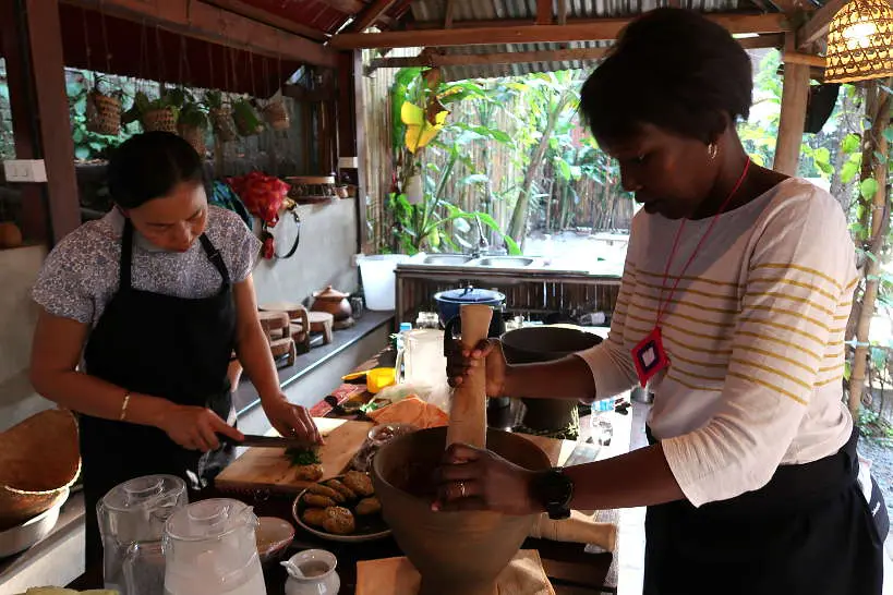 Rosemary Pounding with Kheo at Cooking Class Luang Prabang by Authentic Food Quest