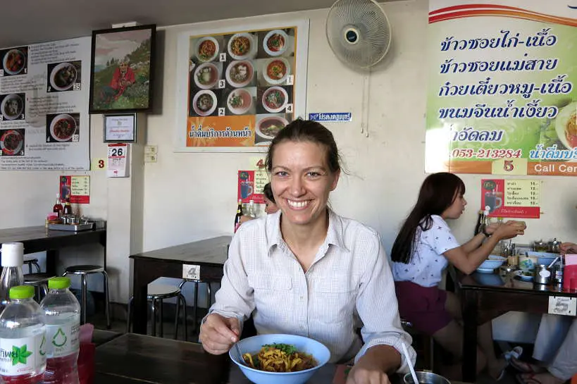 Claire eating at Khao Soi Mae Sai for Best Restaurant in Chiang Mai by Authentic Food Quest