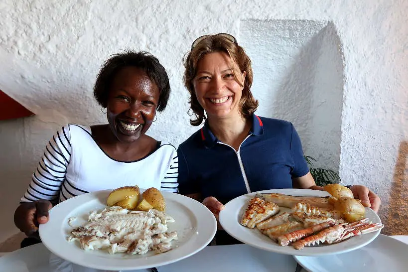 Rosemary and Claire eating grilled fish at Es Baluard Restaurant in Cadaques Costa Brava by AuthenticFoodQuest