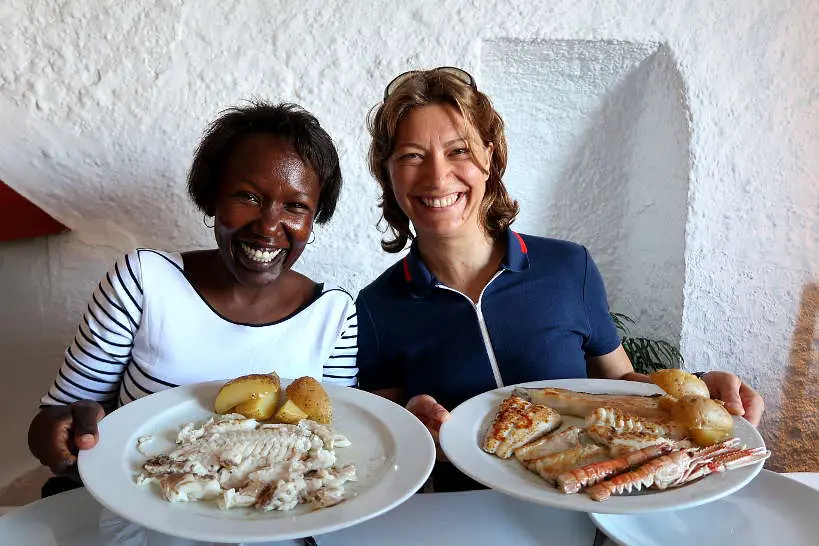 Rosemary and Claire eating grilled fish at Es Baluard Restaurant in Cadaques Costa Brava by Authentic Food Quest