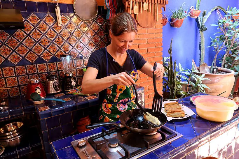 Claire cooking chile rellenos at La Cocina Oaxaquena by Authentic Food Quest