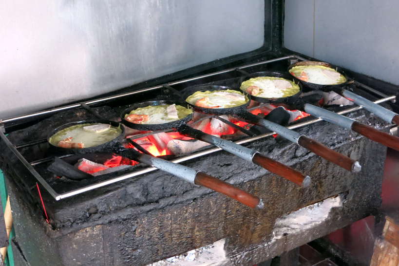 Banh Xeo Being Cooked over charcoal by AuthenticFoodQuest