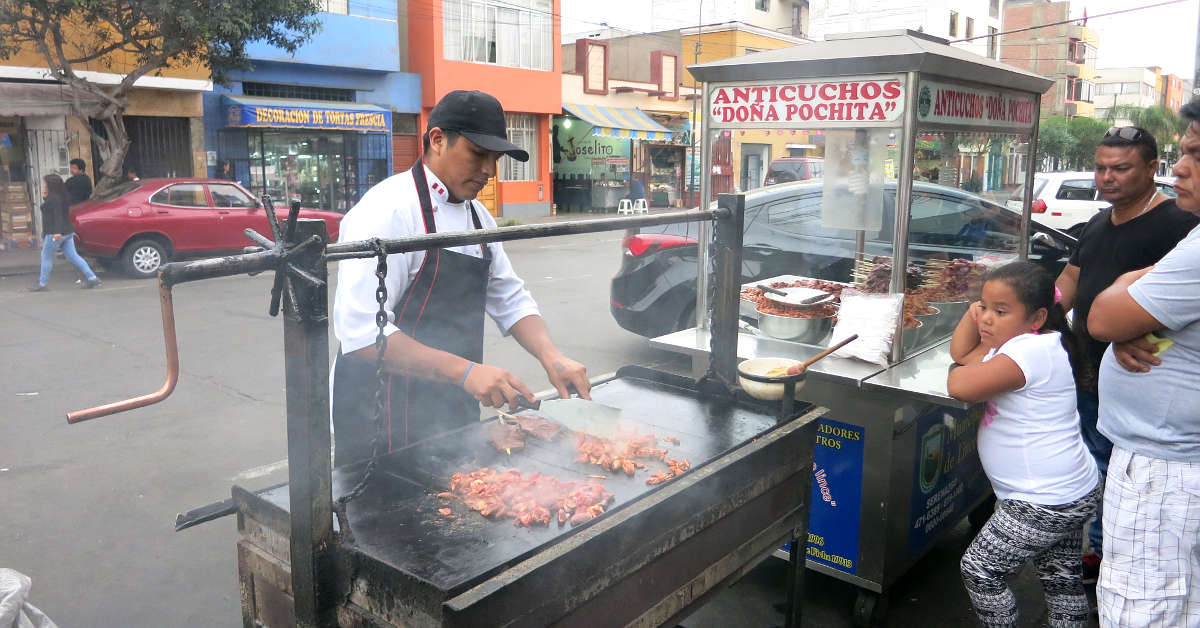 dona pochita street cart Grilling Anticuchos a popular peru street food in Lima by Authentic Food Quest