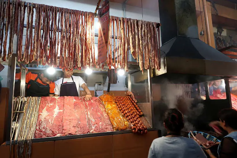 Grilling tasajo at Mercado 20 Noviembre Oaxaca market by Authentic Food quest