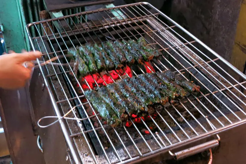 Bo la lot grilling beef in betel leaves for food in Saigon by Authentic Food Quest