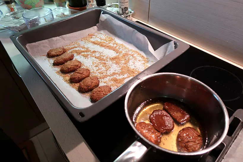 Dipping into syrup recipe for melomakarona by Authentic Food Quest