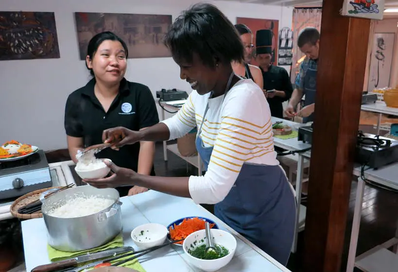 Rosemary learning how to cook broken rice in Saigon Vietnam by AuthenticFoodQuest
