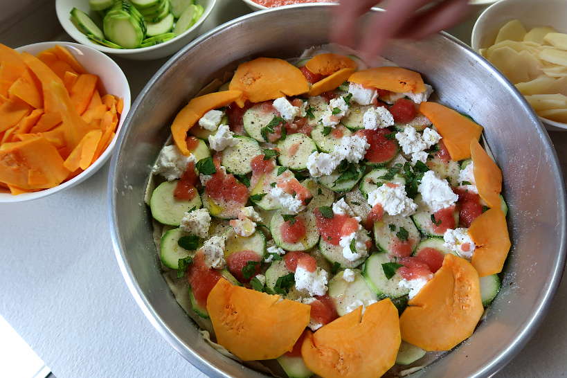 Adding layer of pumpkin squash boureki recipe by Authentic Food Quest