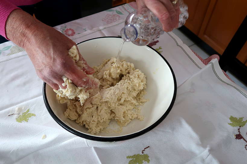 Adding water to make phyllo dough by Authentic Food Quest