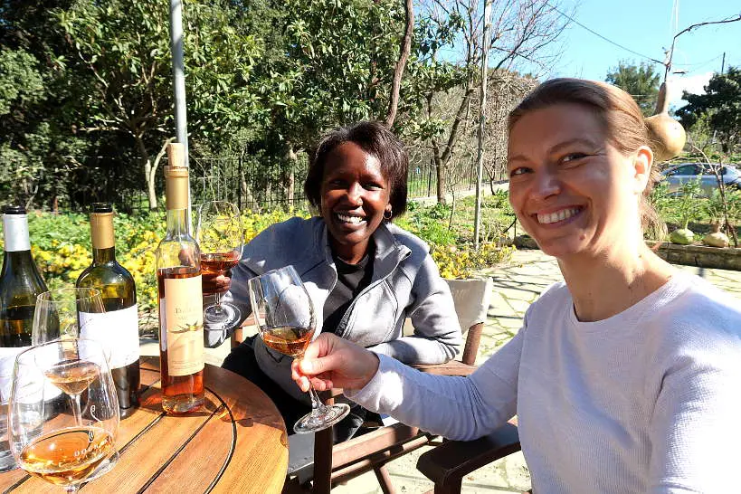 Rosemary and Claire tasting sweet romeiko at Dourakis winery by Authentic Food Quest