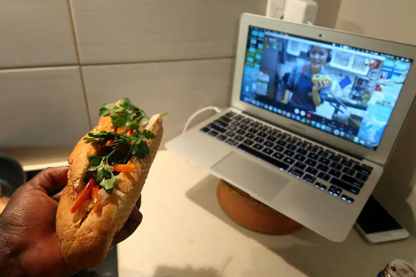 Rosemary showing her banh mi sandwich with The Chef and The Dish for Online Vietnamese Cooking Classes
