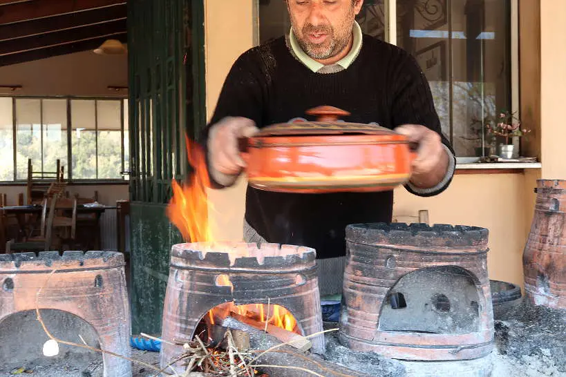 Stelios cooking in clay pot at Dounias restaurant in Chania province Crete by AuthenticFoodQuest