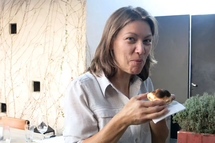 Claire Eating Empanadas in Argentina by AuthenticFoodQuest