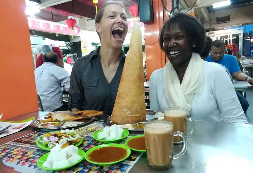 Claire and Rosemary Eating Roti Tisu with Teh Tarik by Authentic Food Quest