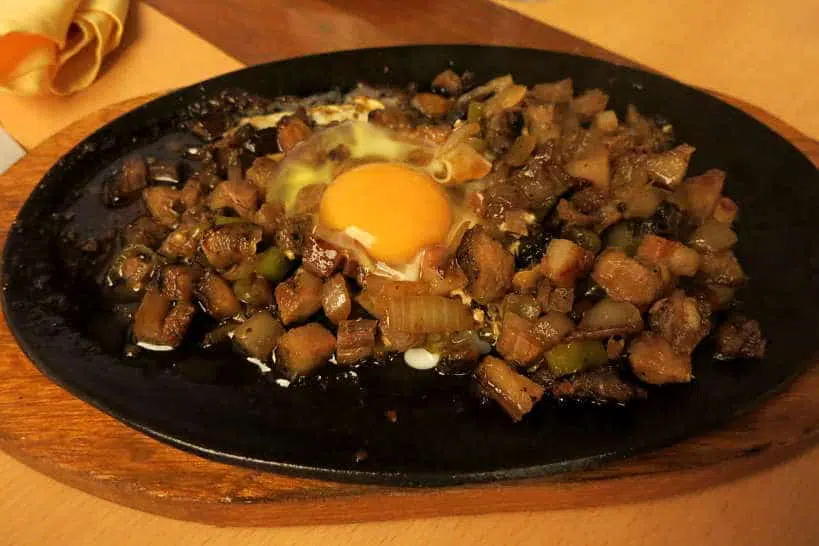 Pork Sisig Served with an Egg by Authentic Food Quest
