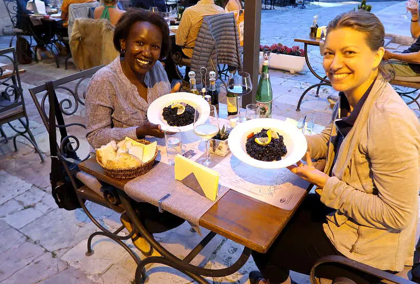 Rosemary and Claire eating black risotto by Authentic Food Quest