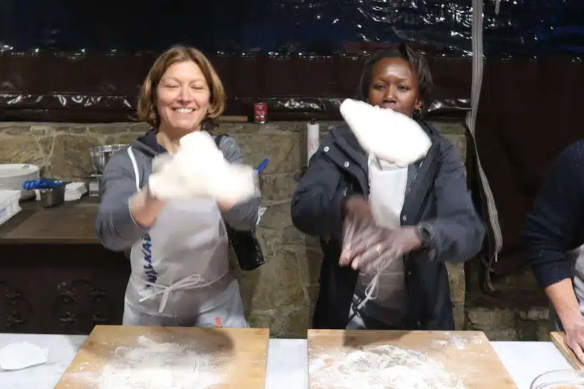 Claire and Rosemary Flipping Pizza in a Cooking Class in Florence by AuthenticFoodQuest