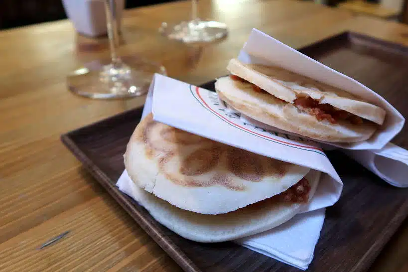 Eating Tigelle sandwich during a Food Tour in Bologna by AuthenticFoodQuest